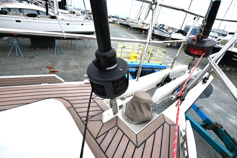 Slide: The Image of Deck view of a 2006 Waterline 50 yacht in a boatyard, featuring winches and rigging. - 15