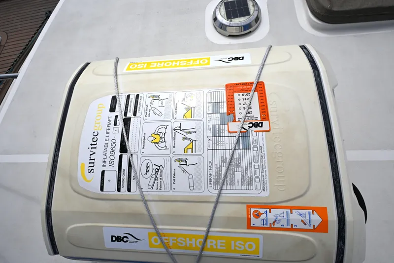 Slide: The Image of Inflatable liferaft on Waterline 50 yacht, 2006 model, secured with ropes, featuring safety instructions. - 17