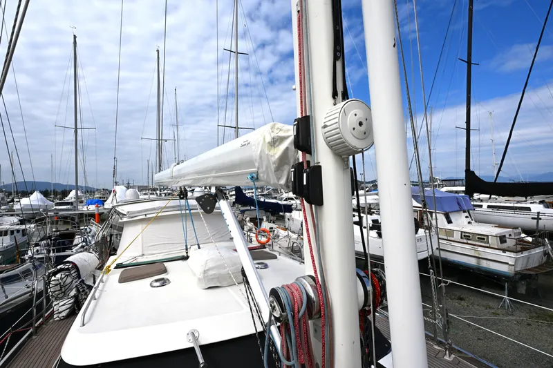 Slide: The Image of Sailboat docked at marina, Waterline 50 model, 2006, surrounded by other boats under a cloudy sky. - 24
