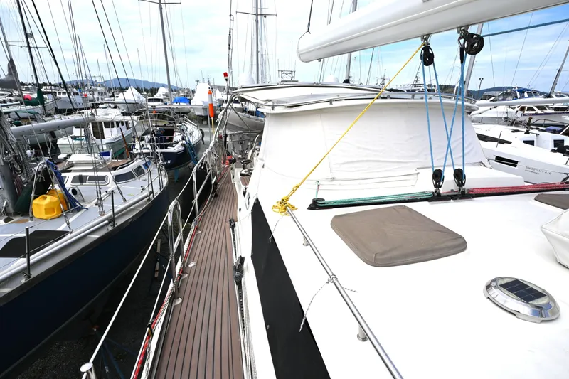 Slide: The Image of Sailboats docked at a marina, featuring a 2006 Waterline 50 yacht. - 28