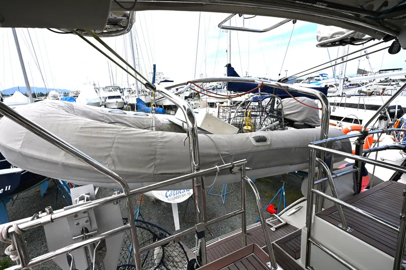 Slide: The Image of Sailboat deck view with covered dinghy, Waterline 50, 2006 model, in a marina setting. - 32