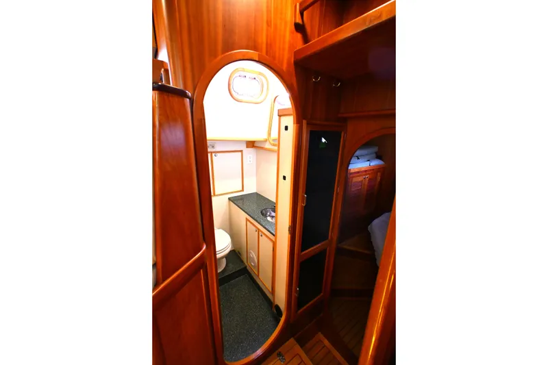 Slide: The Image of Luxurious 2006 Waterline 50 yacht interior with wooden finish and compact bathroom. - 47
