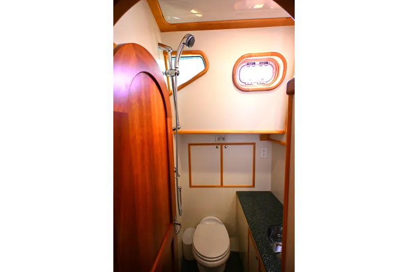 Slide: The Image of Luxurious 2006 Waterline 50 yacht bathroom with wood accents and modern fixtures. - 49