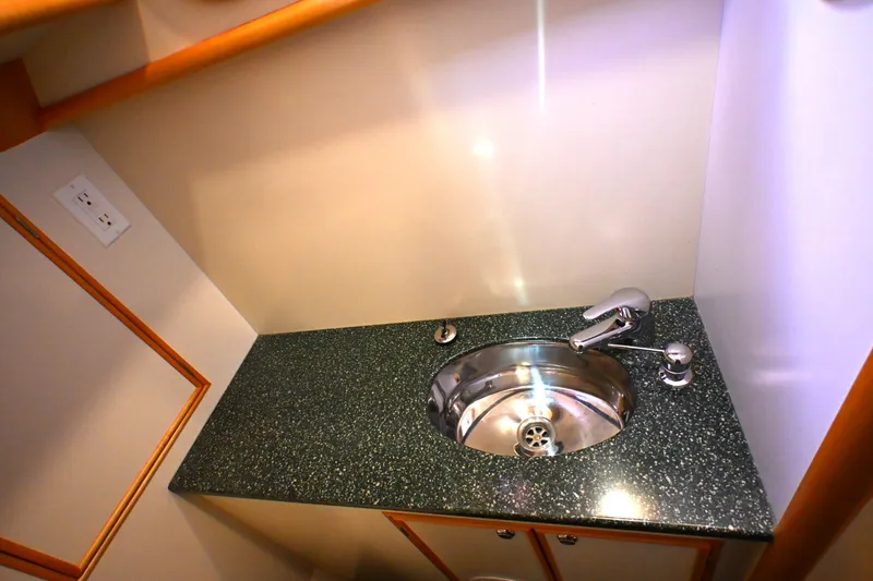 Slide: The Image of Compact bathroom sink with granite countertop in 2006 Waterline 50 yacht. - 50