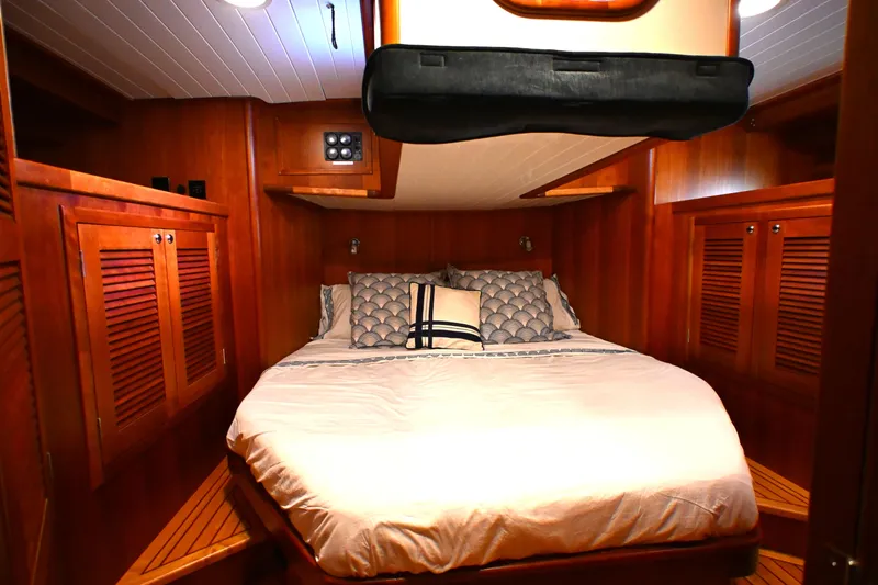 Slide: The Image of Luxurious cabin interior of 2006 Waterline 50 yacht with cozy bedding and wooden finishes. - 52