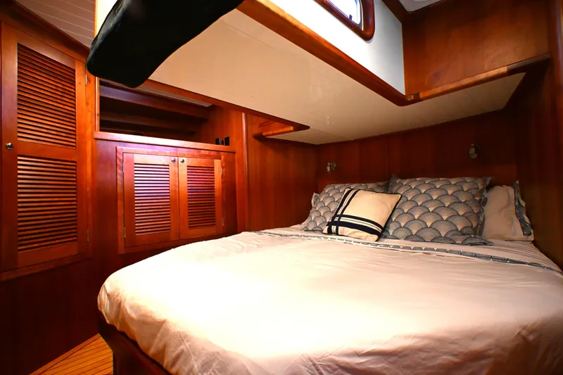 Slide: The Image of Cozy cabin interior of 2006 Waterline 50 yacht with wooden paneling and comfortable bedding. - 53