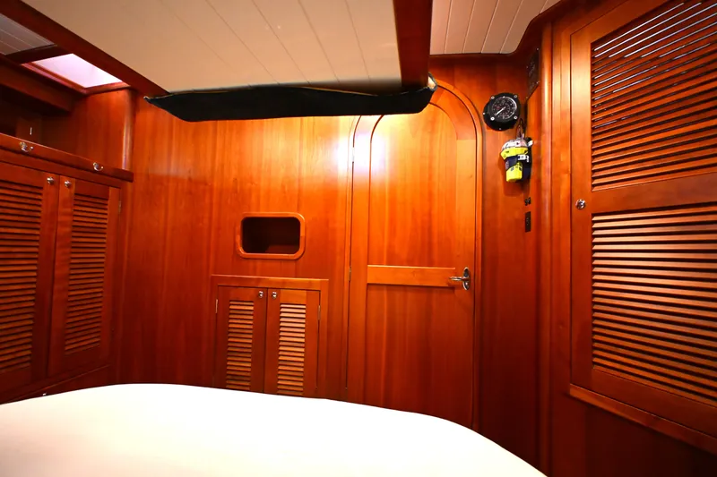 Slide: The Image of Interior of 2006 Waterline 50 yacht with wooden paneling and storage cabinets. - 54