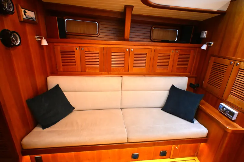 Slide: The Image of Luxurious wooden interior of a 2006 Waterline 50 yacht with beige sofa and cushions. - 59