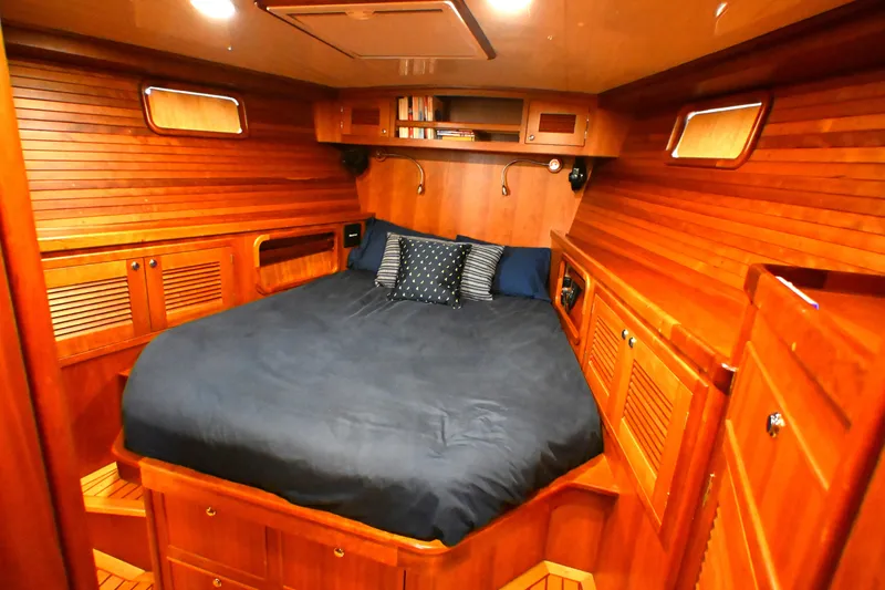 Slide: The Image of Luxurious wooden cabin interior of a 2006 Waterline 50 yacht with cozy bedding. - 61