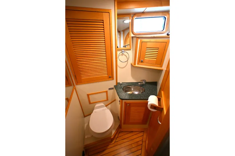 Slide: The Image of Luxurious 2006 Waterline 50 yacht bathroom with wooden cabinetry and modern fixtures. - 66
