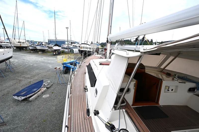 Slide: The Image of 2006 Waterline 50 sailboat on dry dock, surrounded by other boats under a cloudy sky. - 7