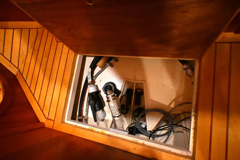 Slide: The Image of Bilge compartment of 2006 Waterline 50 yacht with visible hoses and wiring. - 70