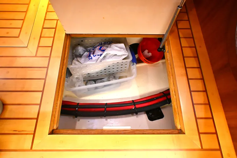 Slide: The Image of Storage compartment on a 2006 Waterline 50 yacht with organized supplies and cables. - 72