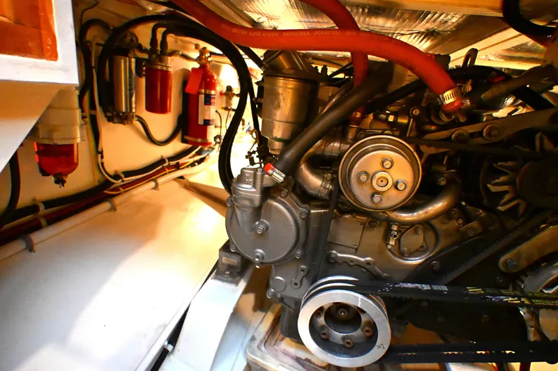 Slide: The Image of Engine room of a 2006 Waterline 50 yacht, showcasing mechanical components and fire extinguishers. - 75