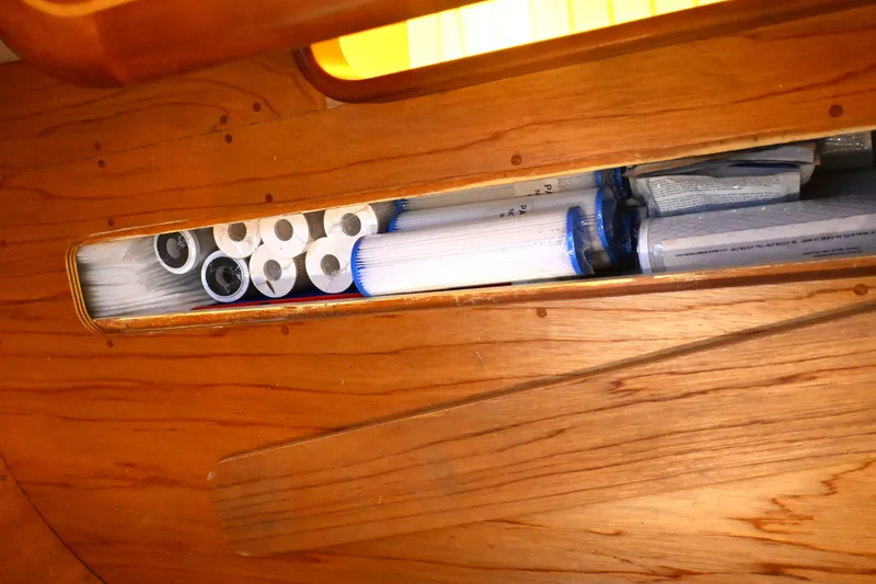 Slide: The Image of Storage compartment with water filters inside a 2006 Waterline 50 boat. - 89