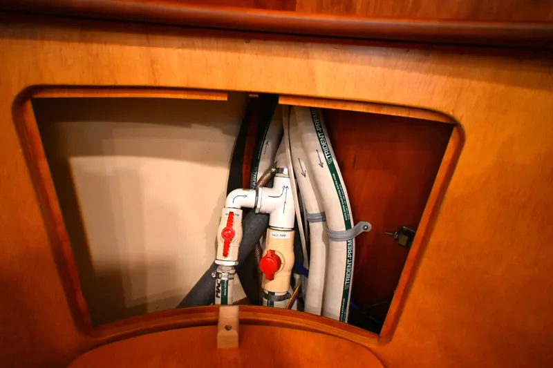 Slide: The Image of Plumbing system inside a 2006 Waterline 50 yacht, featuring valves and hoses. - 91