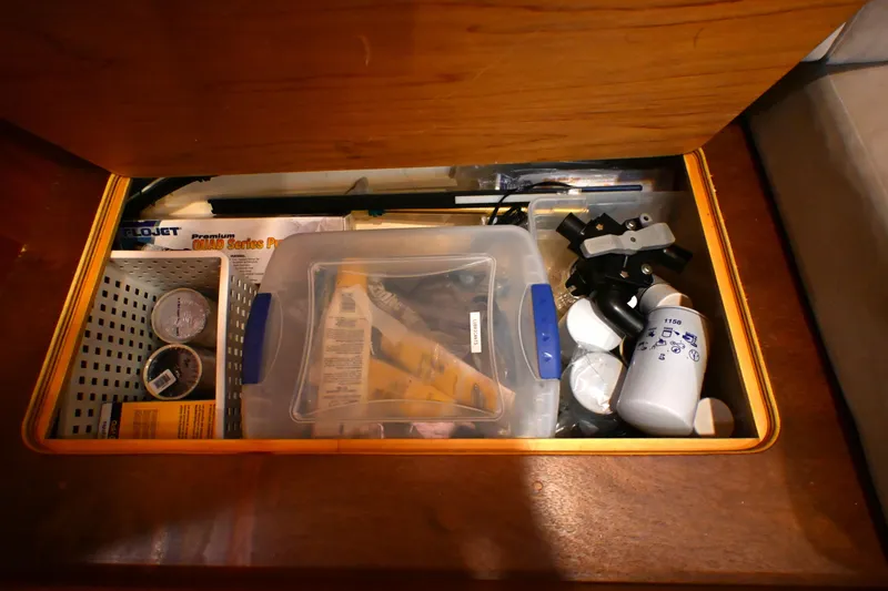 Slide: The Image of Storage compartment on a 2006 Waterline 50 yacht, containing maintenance supplies and tools. - 95