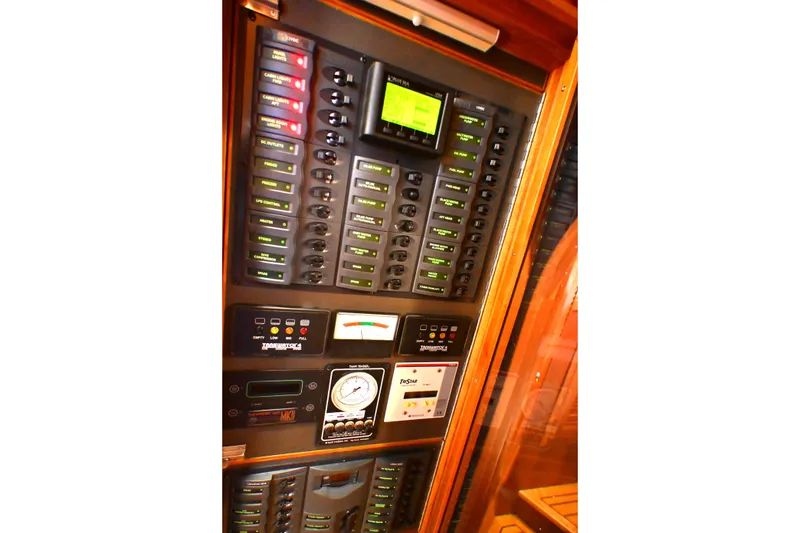 Slide: The Image of Electrical control panel on a 2006 Waterline 50 yacht, featuring various switches and gauges. - 97