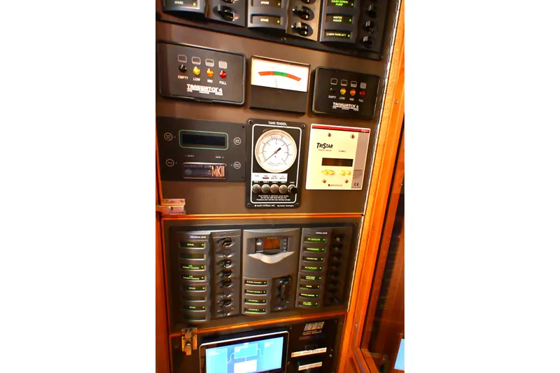 Slide: The Image of Control panel of a 2006 Waterline 50 yacht, featuring various gauges and switches. - 98