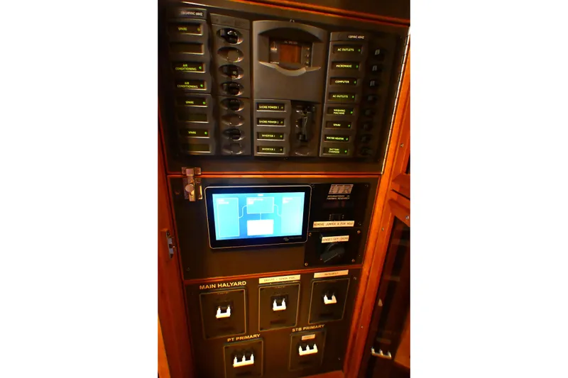 Slide: The Image of Electrical control panel on a 2006 Waterline 50 yacht, featuring switches and a digital display. - 99