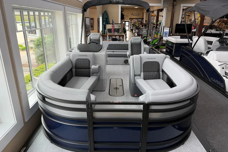 Slide: The Image of 2026 Harris Solstice 230 SLDH pontoon boat with luxurious seating in showroom. - 1