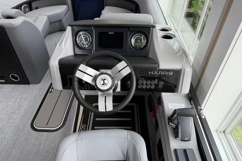 Slide: The Image of Steering console of 2026 Harris Solstice 230 SLDH boat with modern controls and gauges. - 5