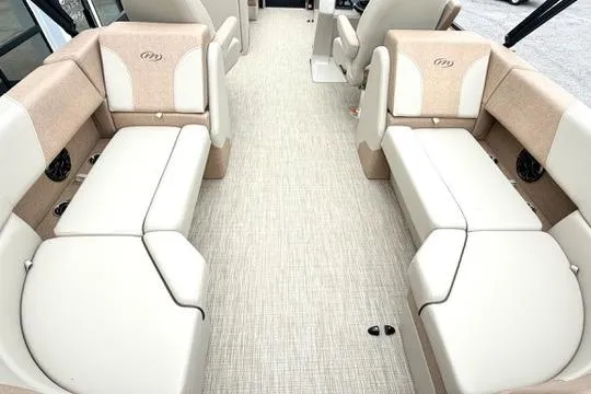 Slide: The Image of Interior of 2026 Manitou Aurora RF 23 boat with beige seating and carpeted floor. - 11
