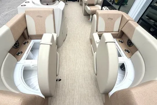 Slide: The Image of Interior of 2026 Manitou Aurora RF 23 boat with beige seating and storage compartments. - 6