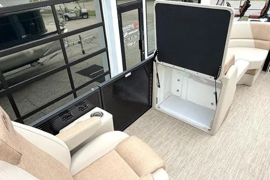 Slide: The Image of Interior of 2026 Manitou Aurora RF 23 pontoon boat with beige seating and storage compartment. - 8