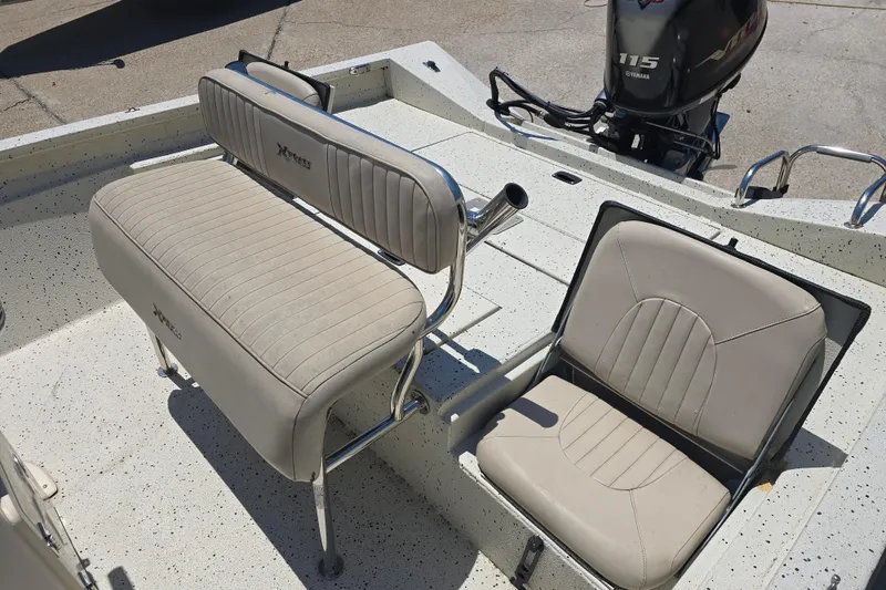 Slide: The Image of 2016 Xpress H20B Bay boat interior with beige seating and Yamaha 115 outboard motor. - 12