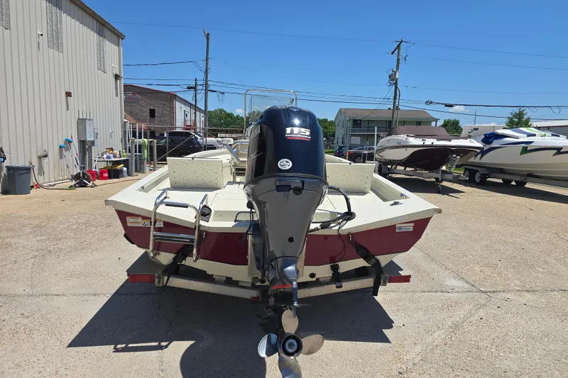 Slide: The Image of 2016 Xpress H20B Bay boat with outboard motor in a marina setting. - 4