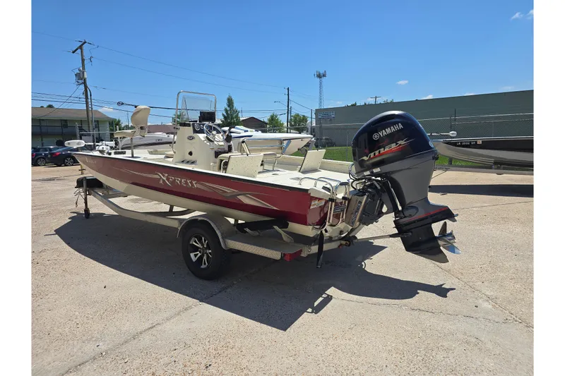 Slide: The Image of 2016 Xpress H20B Bay boat with Yamaha outboard motor on trailer, parked outdoors. - 5