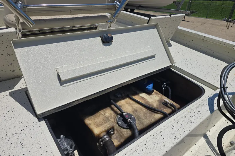 Slide: The Image of Open storage compartment on 2016 Xpress H20B Bay boat, revealing internal components. - 9