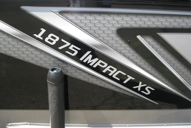 Slide: The Image of 2026 Lund 1875 Impact XS Sport boat logo with sleek design elements. - 12