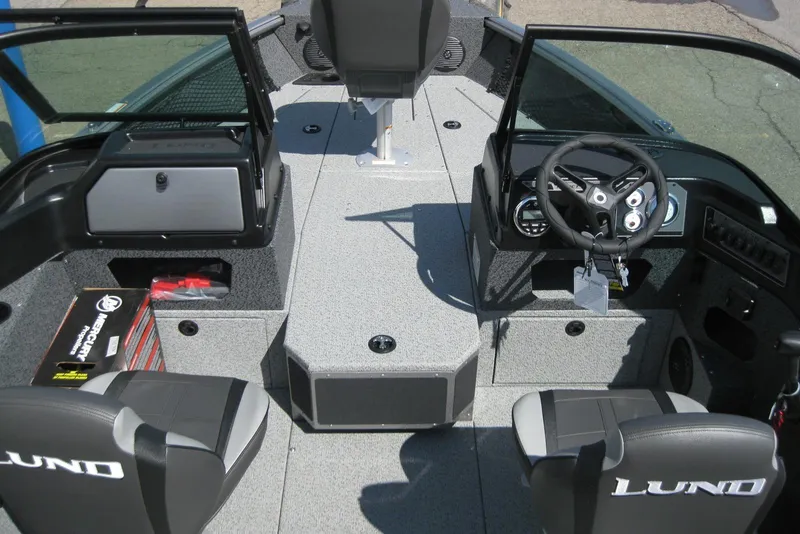 Slide: The Image of 2026 Lund 1875 Impact XS Sport boat interior with steering console and seating. - 16