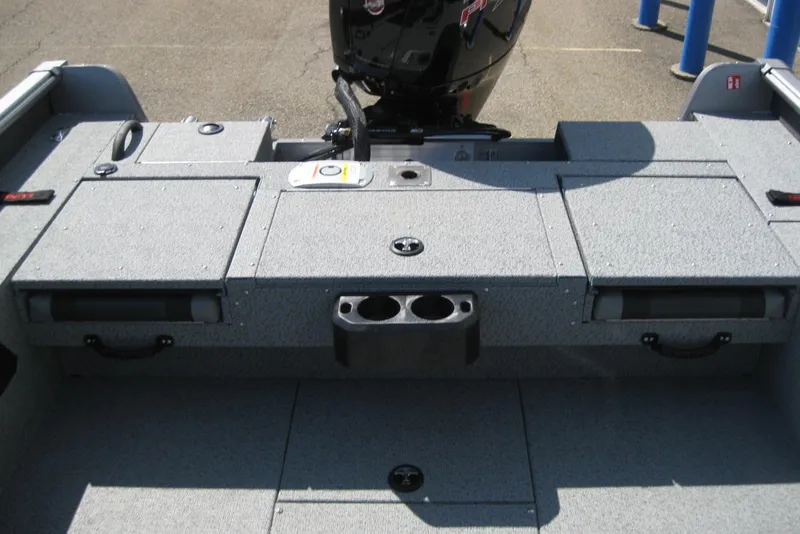 Slide: The Image of 2026 Lund 1875 Impact XS Sport boat interior with storage compartments and cup holders. - 17