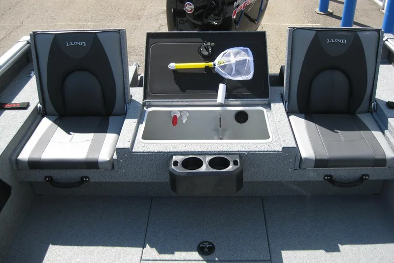 Slide: The Image of 2026 Lund 1875 Impact XS Sport boat interior with seating and storage compartments. - 18