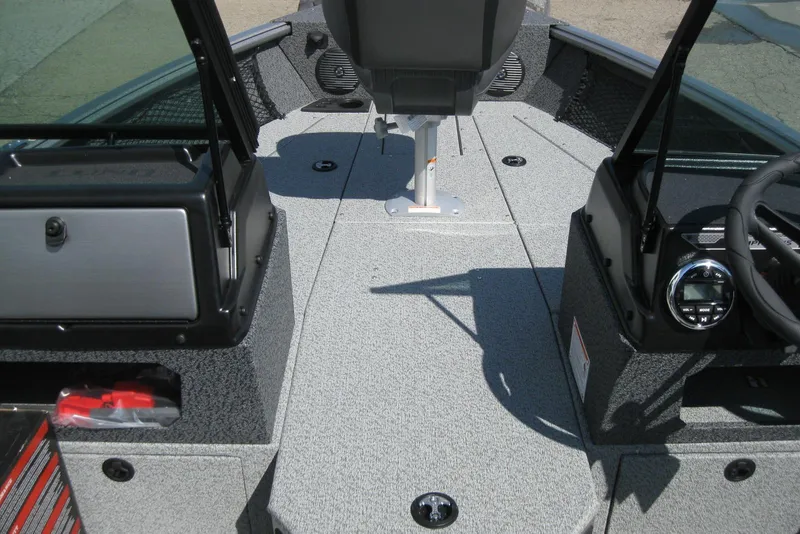Slide: The Image of 2026 Lund 1875 Impact XS Sport boat interior with seating and control panel. - 21