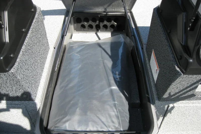 Slide: The Image of 2026 Lund 1875 Impact XS Sport boat storage compartment with rod holders and protective cover. - 22