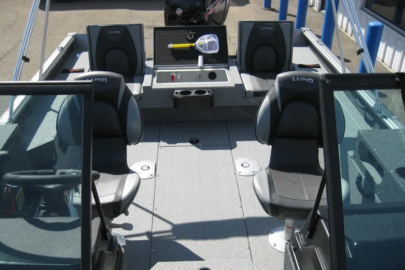 Slide: The Image of 2026 Lund 1875 Impact XS Sport boat interior with seating and fishing gear. - 23