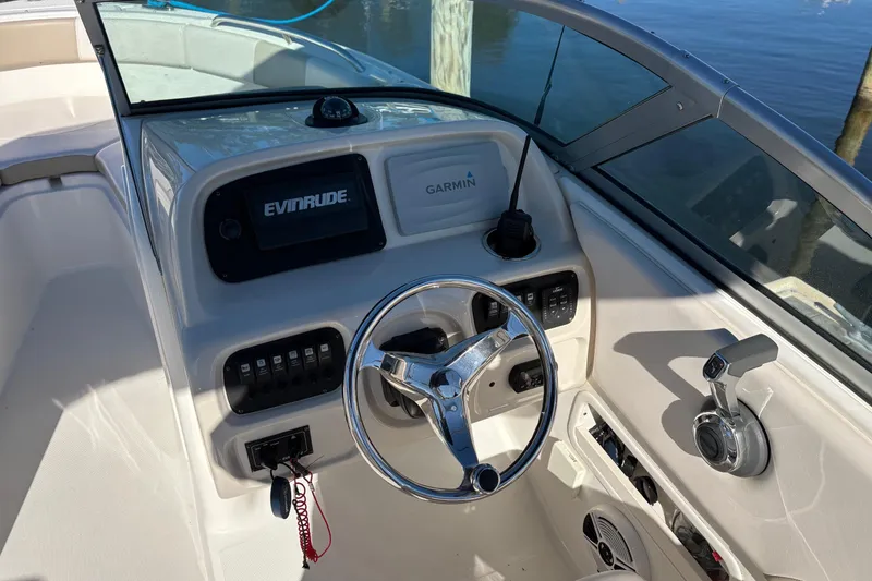 Slide: The Image of 2017 Robalo R227 Dual Console boat dashboard with Evinrude and Garmin displays. - 10