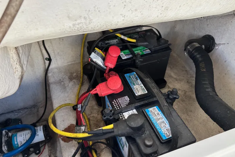 Slide: The Image of Battery compartment of a 2017 Robalo R227 Dual Console boat with wiring connections. - 18