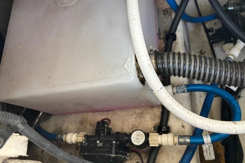 Slide: The Image of 2017 Robalo R227 Dual Console boat plumbing system with hoses and fittings. - 20
