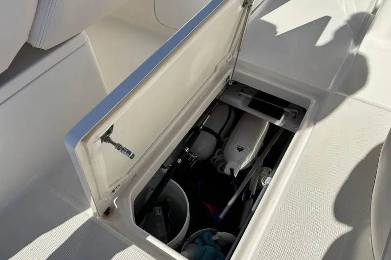 Slide: The Image of Storage compartment on a 2017 Robalo R227 Dual Console boat, containing boating equipment. - 23