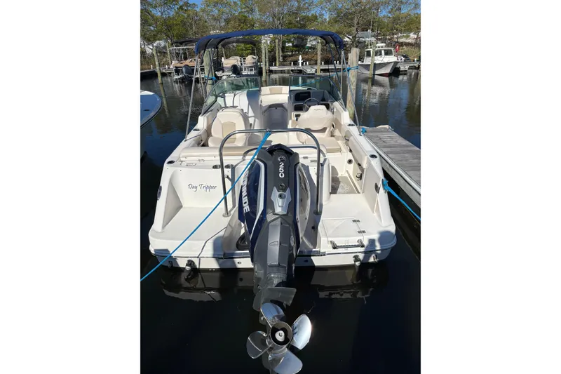 Slide: The Image of 2017 Robalo R227 Dual Console boat docked, featuring an Evinrude outboard motor. - 3
