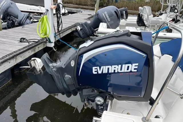 Slide: The Image of 2017 Robalo R227 Dual Console with Evinrude outboard motor at dock. - 7