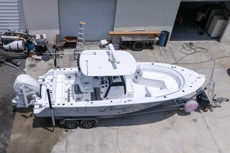 Slide: The Image of 2023 Sportsman Heritage 261 Center Console boat on trailer, aerial view. - 102