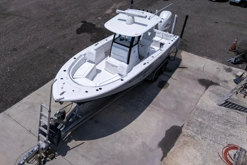 Slide: The Image of 2023 Sportsman Heritage 261 Center Console boat with Yamaha 425 V8 engine, parked on pavement. - 103