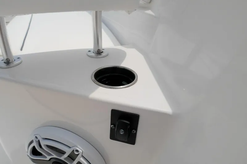 Slide: The Image of 2023 Sportsman Heritage 261 Center Console boat storage with life jackets. - 26