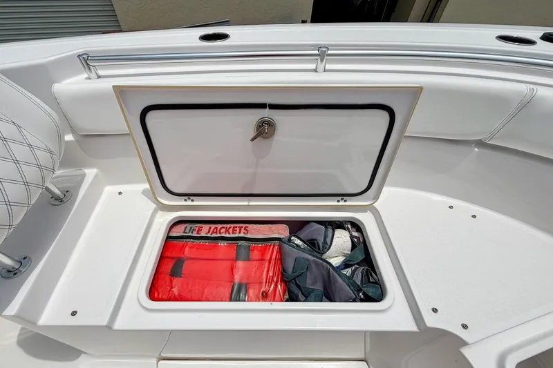 Slide: The Image of 2023 Sportsman Heritage 261 Center Console boat with open storage compartment. - 28